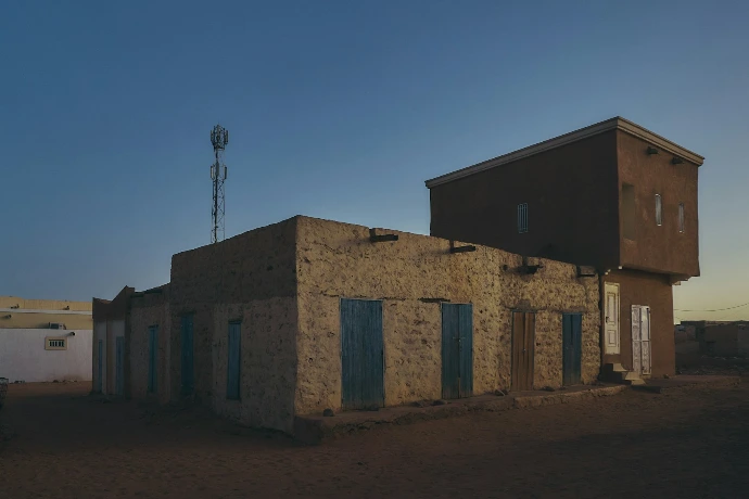 An old building with a windmill in the background